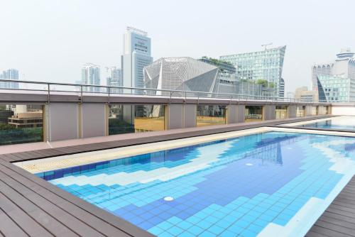 a swimming pool on the roof of a building at Hotel Grand Central in Singapore