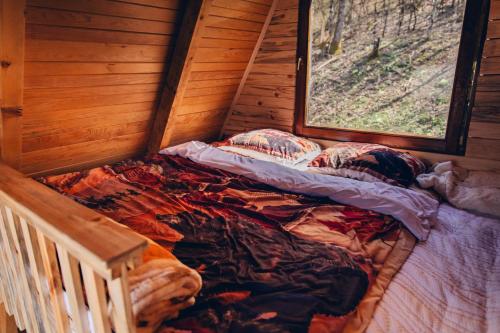 a bed in the corner of a room with a window at Mountain View in Tjentište