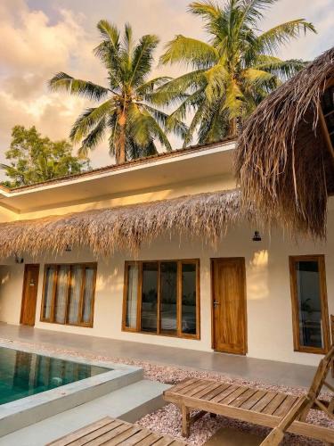 a villa with a swimming pool and a resort at CASA Habibi in Kuta Lombok