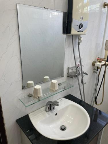 a bathroom with a sink and a mirror at Beachside home in Phú Quốc