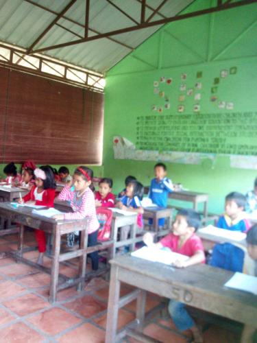 a group of children sitting at desks in a classroom at Sok Phen Homestay in Siem Reap