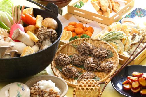 a table with baskets of different types of food at Hotel Japan Shiga in Yamanouchi