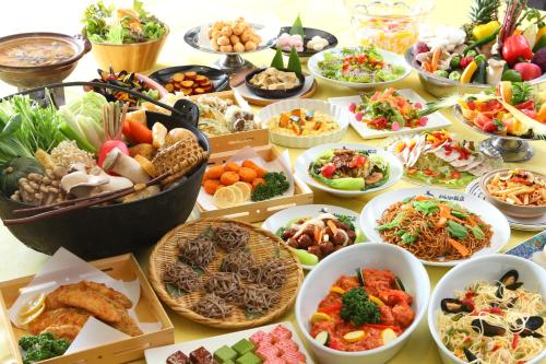 a table topped with lots of different types of food at Hotel Japan Shiga in Yamanouchi