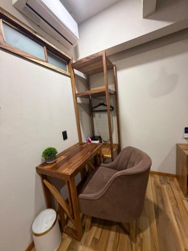 a tiny room with a desk and a chair at Casa Bocobá in Oaxaca City