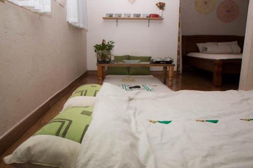 a room with two large beds in a room at Lydia Craft Guesthouse in Seoul