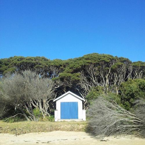 a small blue and white shed on the beach at Sunset Over Sea Little Beachside Villa Rosebud McCrae in Rosebud