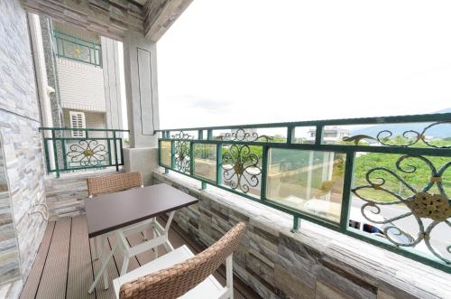 a balcony with a table and chairs and a window at Taiping 528 in Taiping