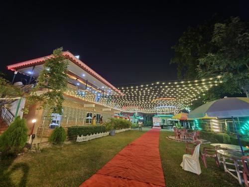 a building with a red carpet and lights on it at North Queen in Lataguri