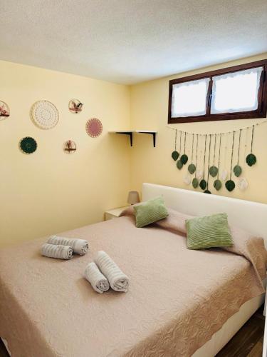 a bedroom with a bed with two towels on it at Appartamento Aurora in Orosei