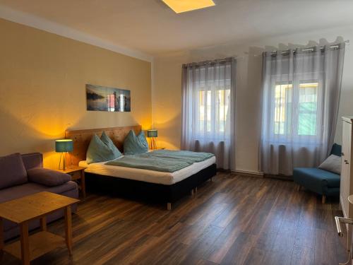 a bedroom with a bed and a couch at Familienferienhaus Amelie in Mörbisch am See