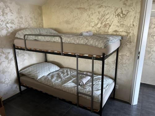 a couple of bunk beds in a room at MAX apartmán jazero in Trstice