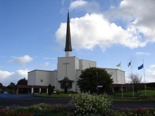 a church with a tall steeple on top of it at Rosmo House B&B in Westport