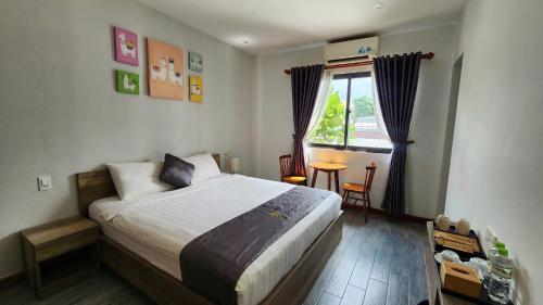 a bedroom with a large bed and a window at Sun Nova Home Phu Quoc in Phú Quốc