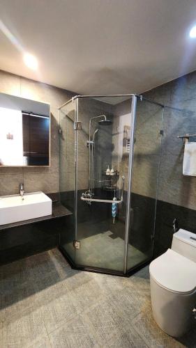 a bathroom with a shower and a toilet and a sink at Sun Nova Home Phu Quoc in Phú Quốc