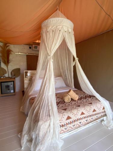 a bed in a tent with mosquito netting at Exotic private glamping in Nusa Penida