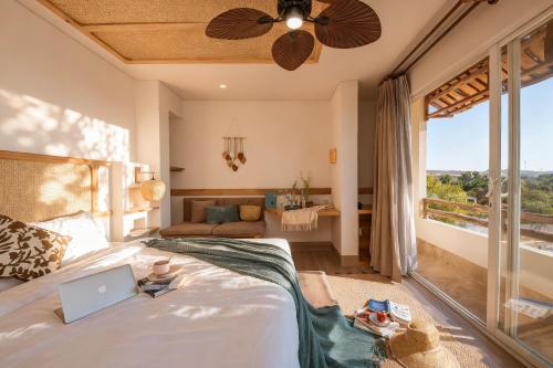 a bedroom with a bed with a laptop on it at La Brise in Ấp Khánh Phước (1)