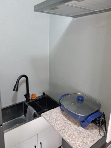 a kitchen with a sink and a blue bowl on a counter at Small Cozy Rest #8 Efficiency in South Bimini