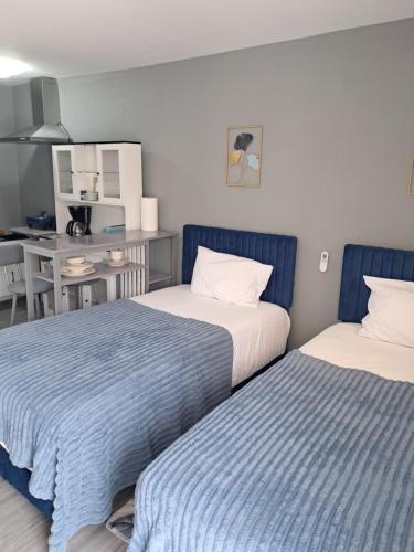 two beds sitting next to each other in a room at Small Cozy Rest #8 Efficiency in South Bimini