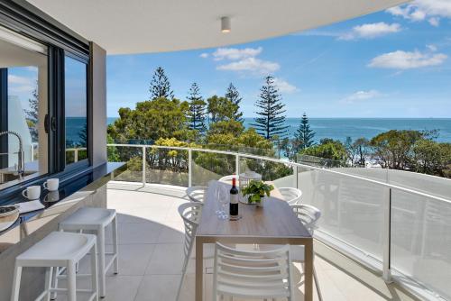 a kitchen and dining room with a view of the ocean at Breeze Mooloolaba, Ascend Hotel Collection in Mooloolaba