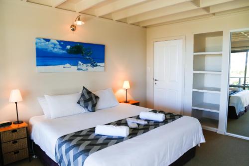 - une chambre avec un grand lit blanc et deux lampes dans l'établissement Pelicans at Denmark, à Denmark