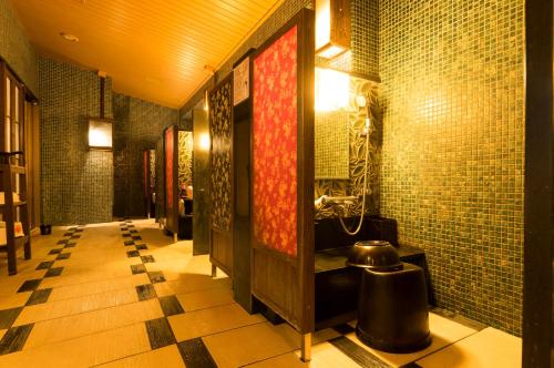 a bathroom with a sink and tiled walls at Dormy Inn Premium Wakayama Natural Hot Spring in Wakayama