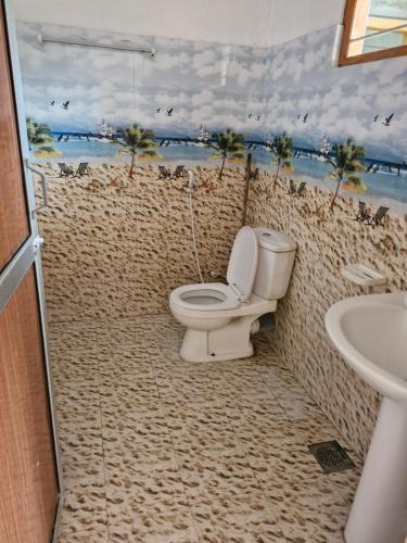 a bathroom with a toilet and a sink at TRINCO VISTARA GUEST House APARTMENT in Trincomalee