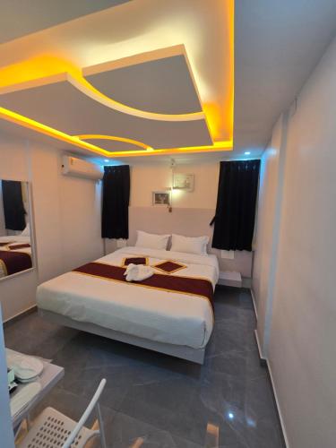 a bedroom with a large bed in a room at Tazinn in Wayanad