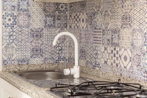 a kitchen counter with a sink and a faucet at Appartamento La terrazza in Baunei