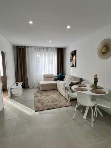 a living room with a couch and a table at Centre-ville de Saint-Brieuc in Saint-Brieuc