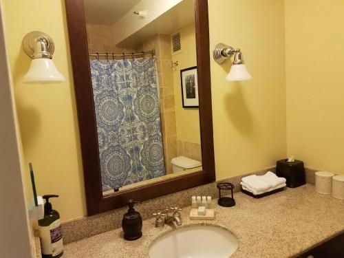 a bathroom with a sink and a mirror at 2417 at Oceanfront Resort Lihue Kauai Beach Drive Private Condo in Lihue