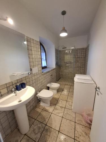 a bathroom with two toilets and a sink at Piccolo Mondo in Perugia