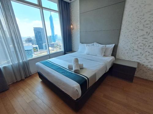 a hotel room with a bed with a large window at Vortex suites klcc by ARICA in Kuala Lumpur