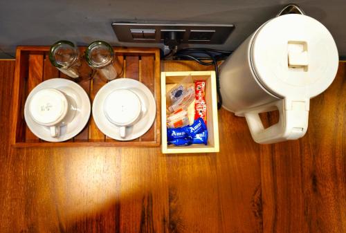 a table with plates and utensils on top of a room at Mayuri Lodge in Kalimpong