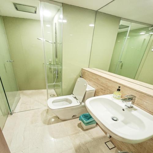 a bathroom with a toilet and a sink and a shower at Vortex suites klcc by ARICA in Kuala Lumpur