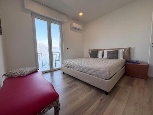 a bedroom with a bed and a large window at CasaPi' in Torri del Benaco