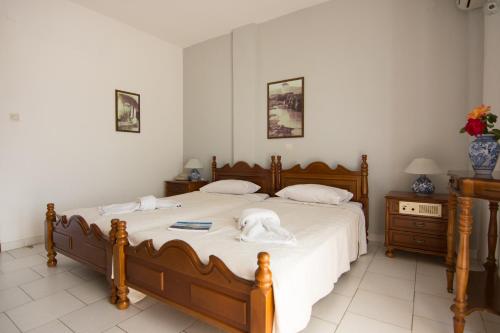 a bedroom with a large bed with towels on it at Hotel Melikari in Skiros