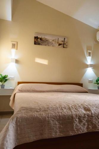 a bedroom with a bed with two lamps on it at ALMA'RE Le Trame di KaSa Experience in Porto Ottiolu