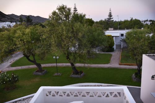 a view of a park with trees and a building at Hotel Melikari in Skiros