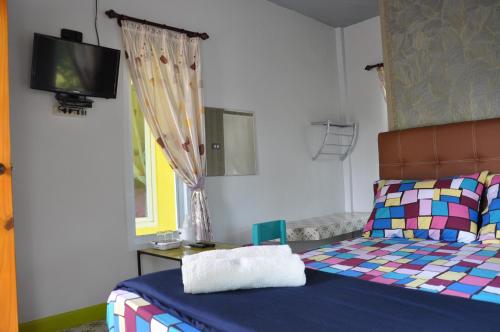 En eller flere senge i et værelse på Feel Good Resort