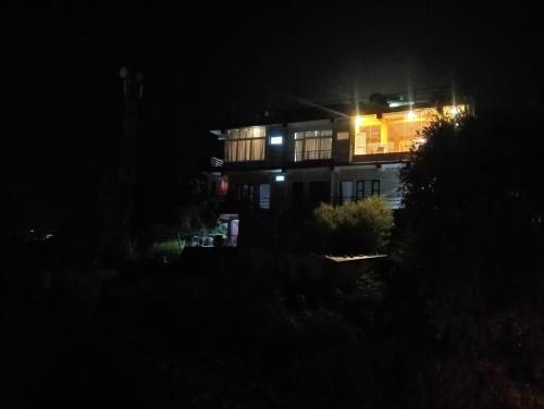 una casa di notte con le luci accese di Dawn view lodge a Pokhara