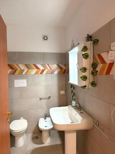 a bathroom with a sink and a toilet at Affittacamere Rosy in Foligno