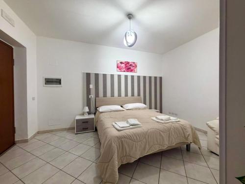 a bedroom with a bed with two towels on it at Affittacamere Rosy in Foligno