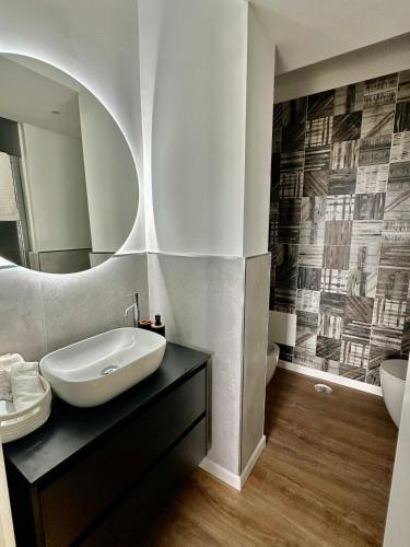 a bathroom with a sink and a mirror at Blu Opèra Guest Rooms in Soverato Marina