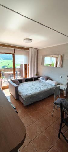 a large bedroom with a large bed and a table at Gaia Bareyo in Bareyo