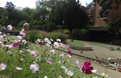 a child standing in a garden with flowers at Hartford Court in Bournemouth