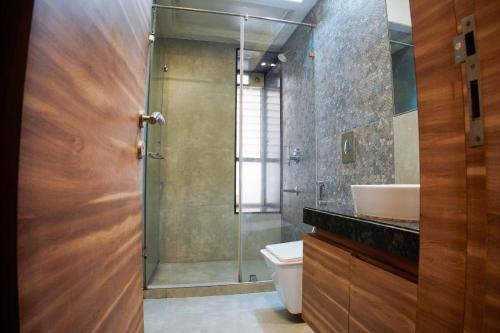 a bathroom with a shower and a toilet and a sink at Shubhham Regency in kolkata