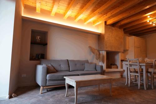 a living room with a couch and a table at Al Cortiletto Apartments in Gardone Riviera