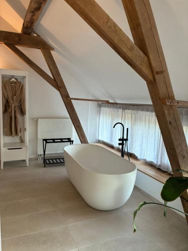 a large white bath tub in a room at EBURON estate Boutique B&B in Diets-Heur