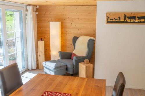 a dining room with a table and a chair and a chair at Ferienhaus Hörli in Sankt Peterzell