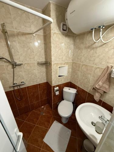 a bathroom with a toilet and a sink at Apartment Sunrise Pomorie in Pomorie